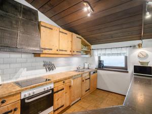 a kitchen with wooden cabinets and a sink and a stove at Apartment Schraudoplh by Interhome in Winklerdörfl +17 photos