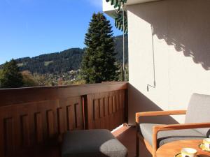 a balcony with a table and chairs and a view of a mountain at Apartment Les Girolles B15 by Interhome in Villars-sur-Ollon