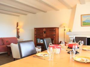 een eetkamer met een tafel met stoelen en een open haard bij Apartment Les Girolles B15 by Interhome in Villars-sur-Ollon