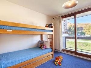 a bedroom with two bunk beds and a window at Apartment Pegase Phenix-10 by Interhome in Le Corbier