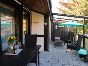 a patio with a table and chairs and an umbrella at Holiday Home Scout by Interhome in Machtlos