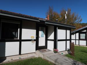a white and black building with a door at Holiday Home Scout by Interhome in Machtlos