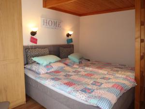 a bedroom with a bed with a home sign on the wall at Holiday Home Scout by Interhome in Machtlos