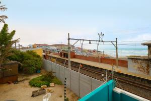 a view of a train station with the ocean at Stoked Backpacker Apartments in Muizenberg