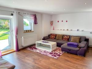 a living room with a couch and a table at Apartment Kühbeck-2 by Interhome in Bischofsmais