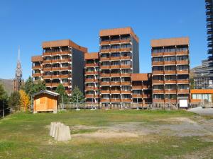 a group of tall buildings in a city at Apartment Burons R05 by Interhome in Les Menuires