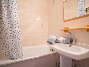 a bathroom with a sink and a shower curtain at Apartment Sarvan 404 by Interhome in Les Menuires