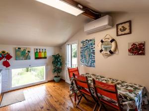 a dining room with a table and chairs and a window at Apartment Villa Volpajola by Interhome in Cervione