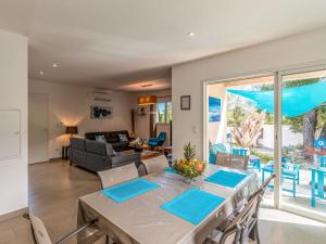 a dining room and living room with a table and chairs at Holiday Home Villa Marie-Jo by Interhome in Cervione