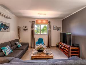 a living room with a couch and a tv at Holiday Home Villa Marie-Jo by Interhome in Cervione
