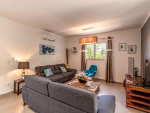 a living room with a couch and a table at Holiday Home Villa Marie-Jo by Interhome in Cervione