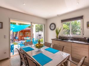 a kitchen and dining room with a table and chairs at Holiday Home Villa Marie-Jo by Interhome in Cervione