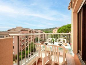 a balcony with a table and chairs and a view at Apartment Les Pins Ensoleilles-6 by Interhome in Sainte-Maxime