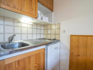 a small kitchen with a sink and a dishwasher at Apartment Les Asters-32 by Interhome in Les Menuires