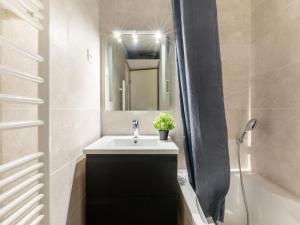 a bathroom with a sink and a mirror at Apartment Les Jardins d'Ys-4 by Interhome in Les Issambres