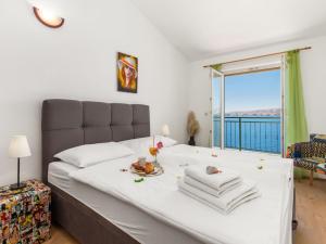 a bedroom with a bed with a view of the ocean at Apartment Marina-6 by Interhome in Senj