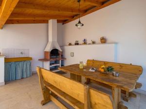 a dining room with a wooden table and benches at Apartment Marina-6 by Interhome in Senj +38 photos