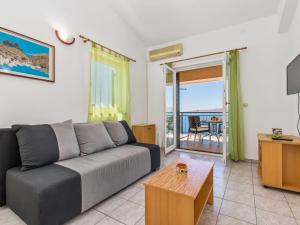 a living room with a couch and a table at Apartment Marina-6 by Interhome in Senj