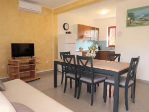 a kitchen and dining room with a table and chairs at Holiday Home Fortica - LBN330 by Interhome in Nedeščina