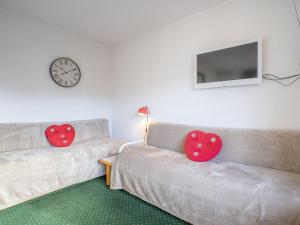 two heart cushions sitting on a couch in a living room at Apartment Nécou-1 by Interhome in Les Menuires