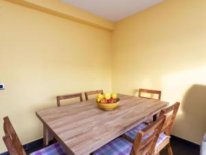 a wooden table with a bowl of fruit on it at Apartment Santa Cruz by Interhome in Blanes