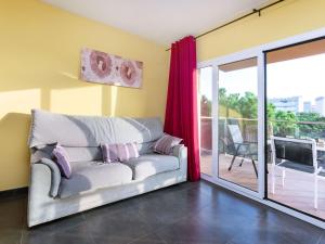 a living room with a couch and a sliding glass door at Apartment Santa Cruz by Interhome in Blanes +8 photos