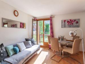 a living room with a couch and a table at Apartment Le Bochate-5 by Interhome in Saint-Pancrace