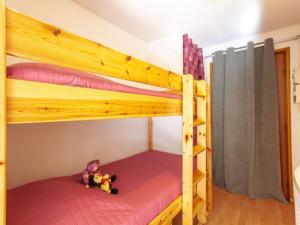 a bunk bed with a teddy bear sitting on the bottom bunk at Apartment Le Bochate-5 by Interhome in Saint-Pancrace