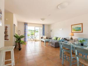 a living room with a couch and a table at Holiday Home Le Mas d'Esquières 7 by Interhome in Les Issambres