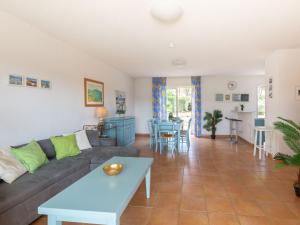 a living room with a couch and a table at Holiday Home Le Mas d'Esquières 7 by Interhome in Les Issambres +27 photos