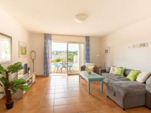 a living room with a couch and a table at Holiday Home Le Mas d'Esquières 7 by Interhome in Les Issambres