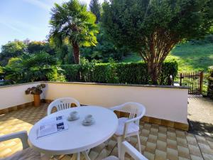 een witte tafel en stoelen op een patio bij Apartment Gobetti by Interhome in Germignaga
