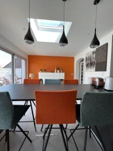 a dining room with a black table and chairs at 11 Port Lin in Le Croisic