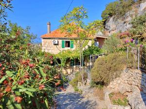 a house on a hill with a garden at Holiday Home Mirna by Interhome in Ložišće