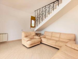 a living room with a couch and a staircase at Villa Aguamarina by Interhome in Miami Platja