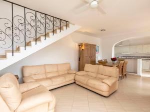 a living room with two couches and a staircase at Villa Aguamarina by Interhome in Miami Platja +22 photos