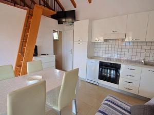 a kitchen with a table and chairs and a stove at Holiday Home Villa Tonka by Interhome in Sutivan