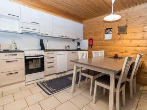 ルカにあるHoliday Home Rukannaava 1a - 2 by Interhomeの木製の壁、テーブルと椅子付きのキッチンが備わります。