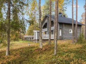 a log cabin in the woods with trees at Holiday Home Joulupukin mökki by Interhome in Sonka