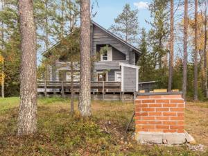 une maison dans les bois avec une cheminée en briques dans l'établissement Holiday Home Joulupukin mökki by Interhome, à Sonka