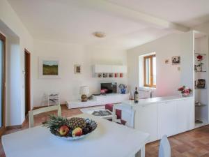 a kitchen and living room with a bowl of fruit on a table at Holiday Home Al Tramonto - Venere by Interhome in Impruneta