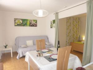 a living room with a table and a couch at Apartment Il était une fois-1 by Interhome in Saint-Aygulf