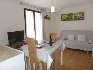 a living room with a table and a couch at Apartment Il était une fois-1 by Interhome in Saint-Aygulf