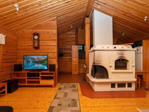 a large living room with a fireplace and a stove at Holiday Home Siula by Interhome in Nissi