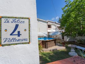 a sign for a house with a table in a yard at Holiday Home Le Querce - PIT550 by Interhome in Atri