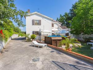 a white house with a bench in the street at Holiday Home Le Querce - PIT550 by Interhome in Atri