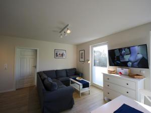 a living room with a couch and a flat screen tv at Apartment Müritz Ferienpark Röbel-6 by Interhome in Röbel