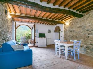 a living room with a blue couch and a table at Apartment Irene by Interhome in Torre SantʼAlluccia