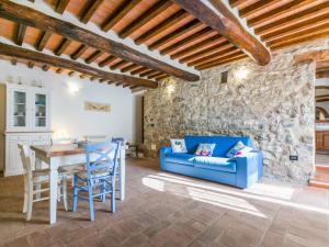 a living room with a blue couch and a table at Apartment Irene by Interhome in Torre SantʼAlluccia