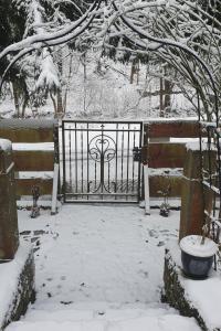 a gate in a yard with snow on it at Holiday Home Karpacz Kowary by Interhome in Kowary